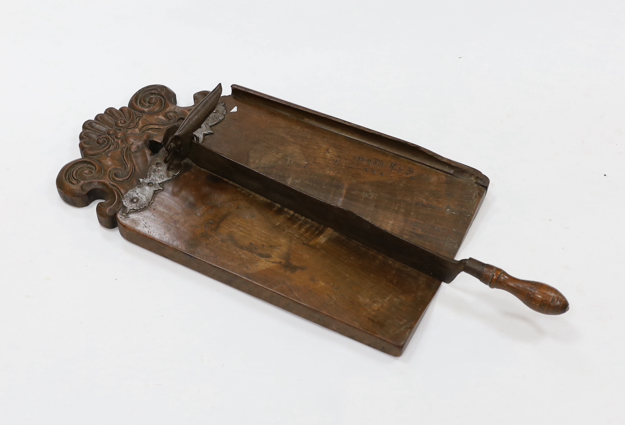 An 18th century Italian carved mahogany bread cutter, mounted wrought and cast iron hinged knife, 80cm high